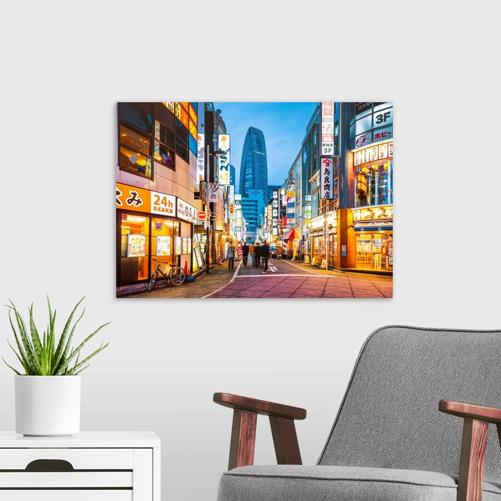 A modern room featuring Shinjuku, Tokyo, Kanto region, Japan. Illuminated neon signs at dusk and Cocoon Tower in the back...