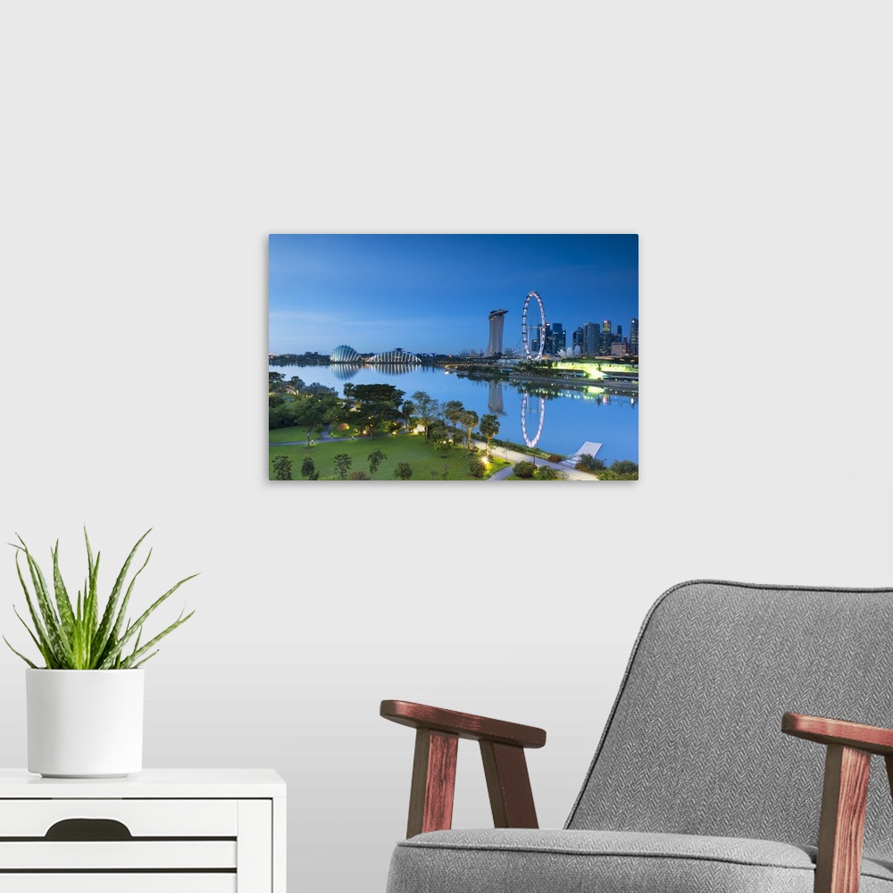 A modern room featuring View of Singapore Flyer, Marina Bay Sands Hotel and Gardens by the Bay at dawn, Singapore.