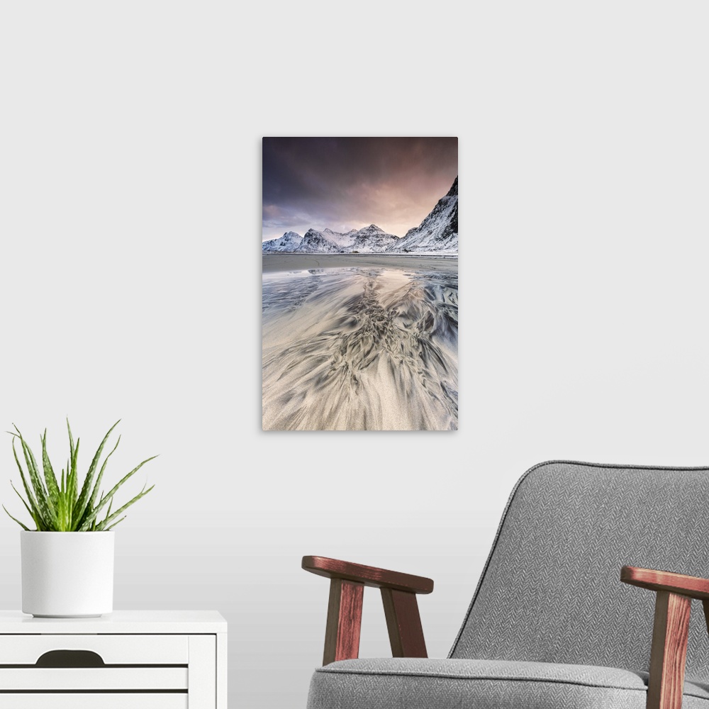 A modern room featuring Pink sky on the surreal Skagsanden beach surrounded by snow covered mountains. Lofoten Islands No...