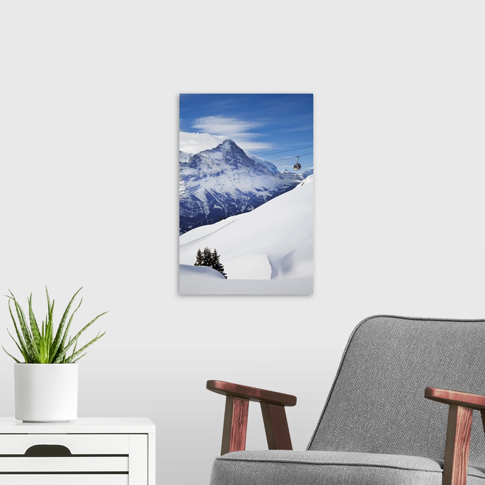 A modern room featuring Ski Gondola lift in front of the North face of the Eiger mountain, Grindelwald, Jungfrau region, ...