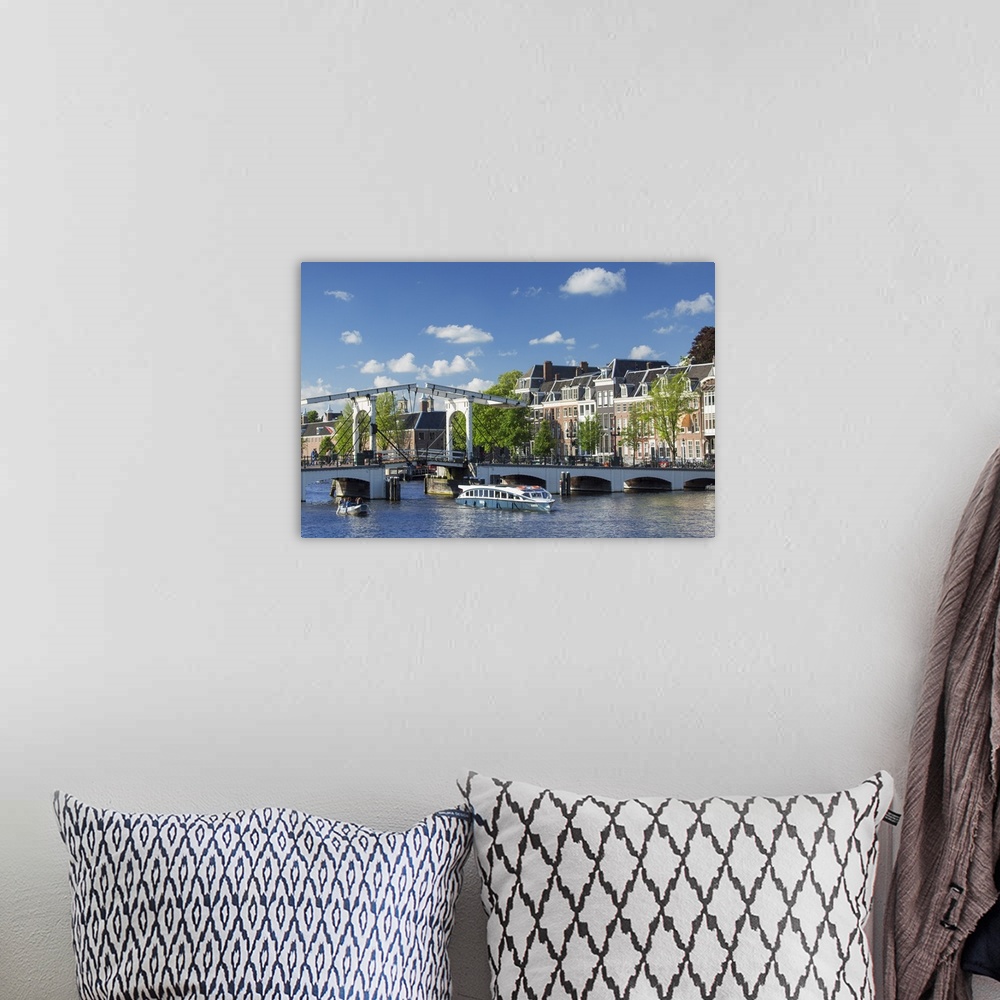 A bohemian room featuring Skinny Bridge (Magere Brug) on Amstel River, Amsterdam, Netherlands.