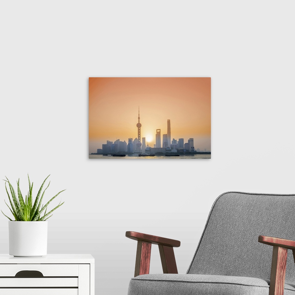 A modern room featuring Asia, China, Shanghai municipality, Shanghai city, sunrise shot showing the skyline of Pudong, wi...