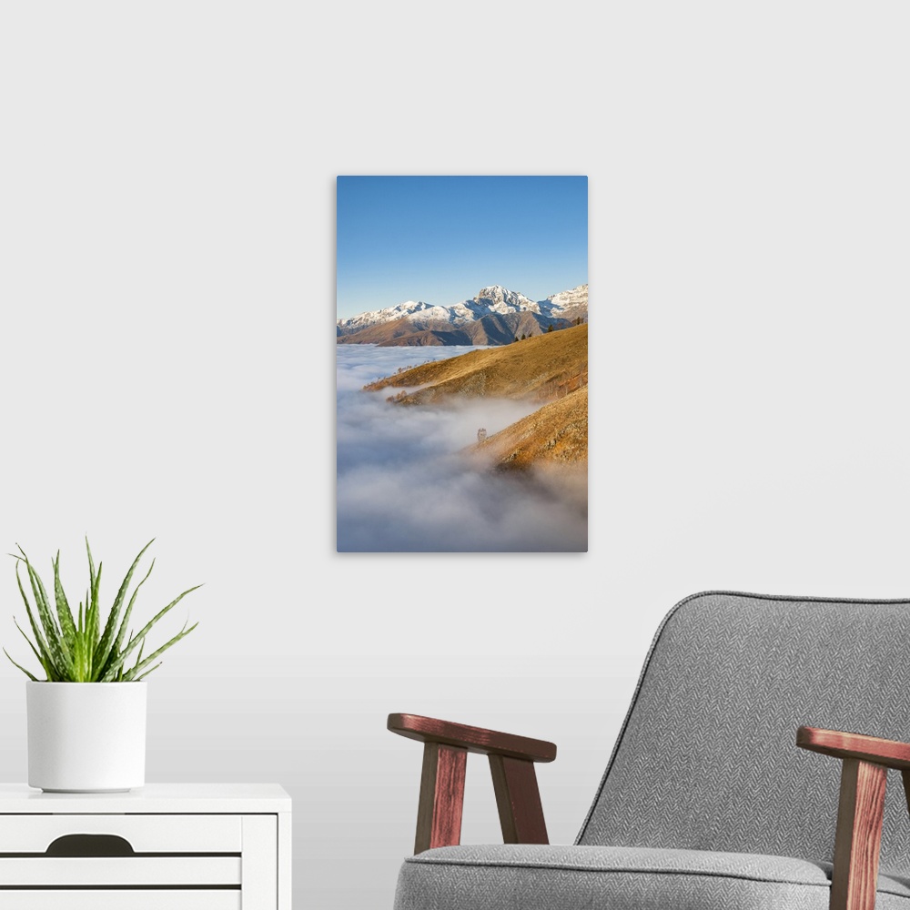 A modern room featuring Snowy mountains over the clouds (Bielmonte, Veglio, Biella province, Piedmont, Italy, Europe).