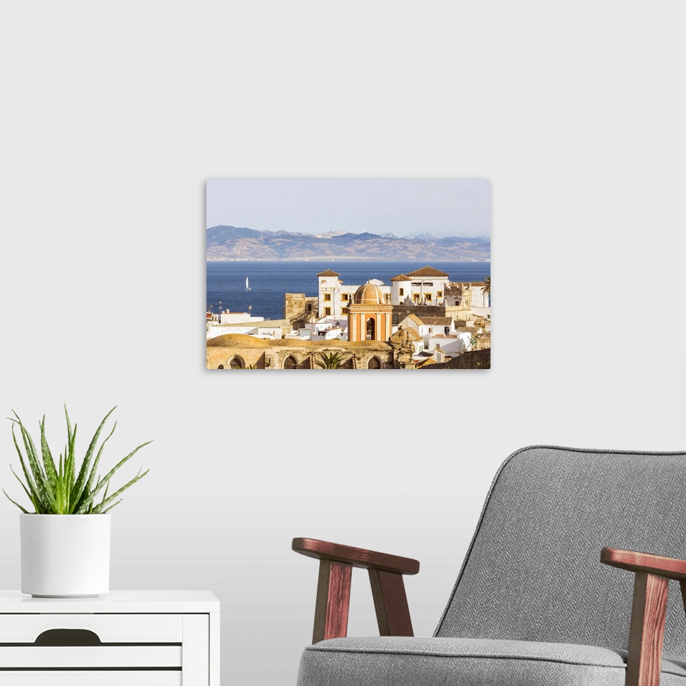 A modern room featuring Spain, Andalusia, Cadiz province, Tarifa. High angle view of the old town with the Straits of Gib...