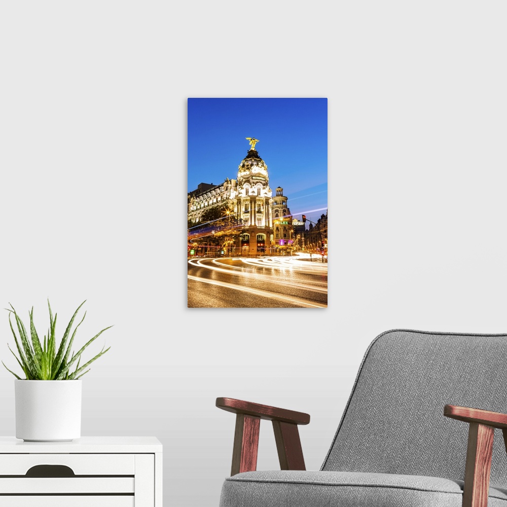 A modern room featuring Spain, Madrid. Cityscape at dusk with famous Metropolis building