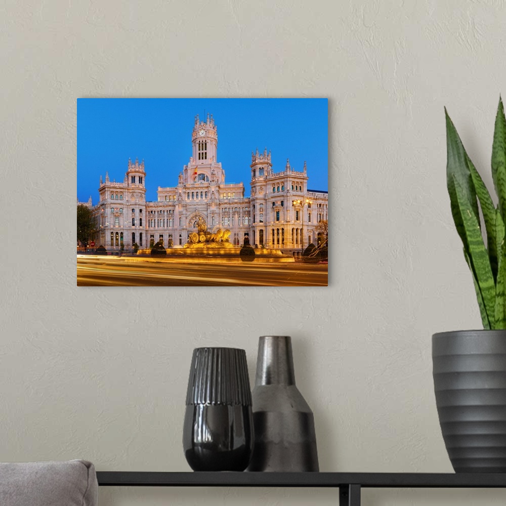A modern room featuring Spain, Madrid. Plaza de Cibeles and town hall at dusk.