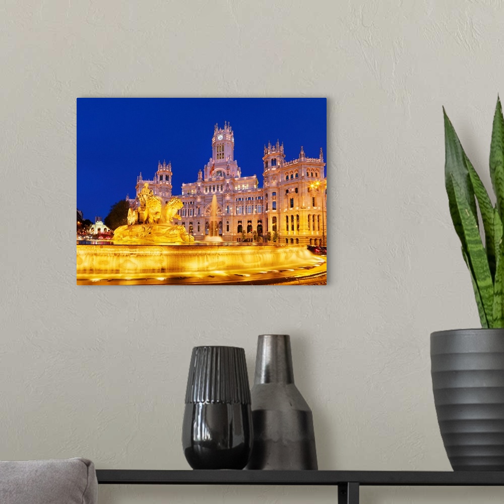 A modern room featuring Spain, Madrid. Plaza de Cibeles and town hall at night.