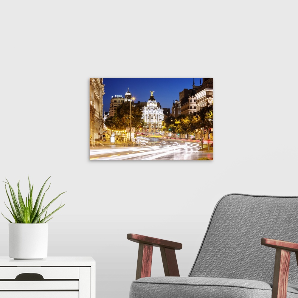 A modern room featuring Spain, Madrid. Street view with Metropolis building and light trails