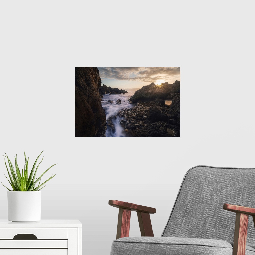 A modern room featuring Spain, Canary Islands, Tenerife, Bocha del Diablo at sunset.