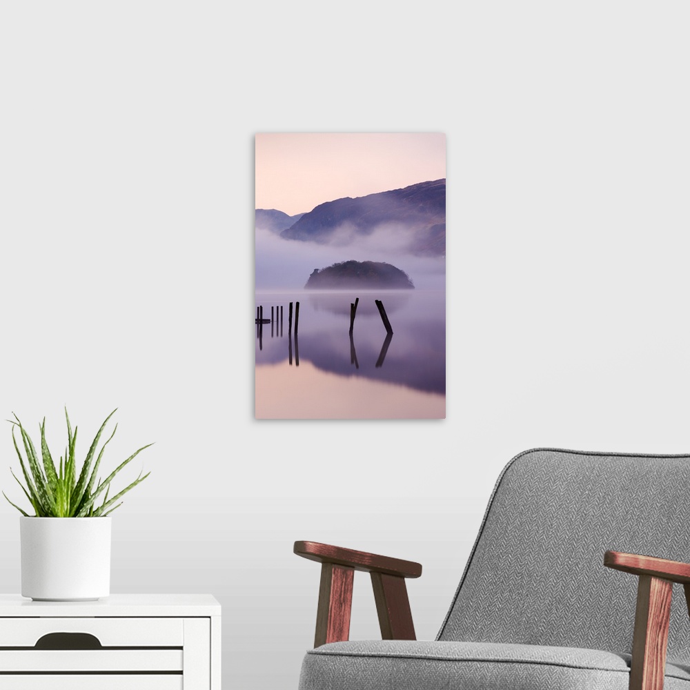 A modern room featuring Old wooden jetty and St Herbert's Island on Derwent Water at dawn on a misty morning, Lake Distri...