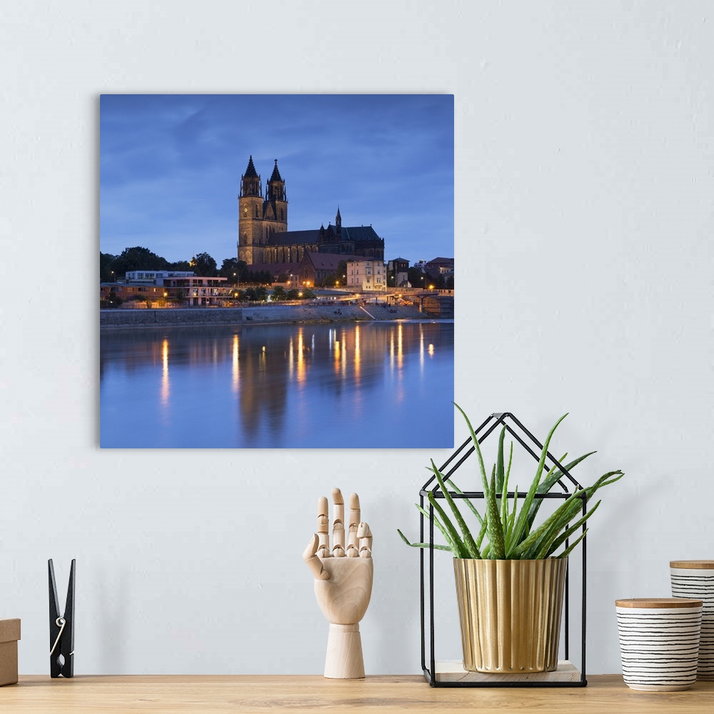 A bohemian room featuring St Mauritius and St Katharina Cathedral and River Elbe at dusk, Magdeburg, Saxony-Anhalt, Germany.