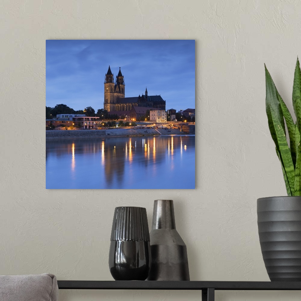 A modern room featuring St Mauritius and St Katharina Cathedral and River Elbe at dusk, Magdeburg, Saxony-Anhalt, Germany.
