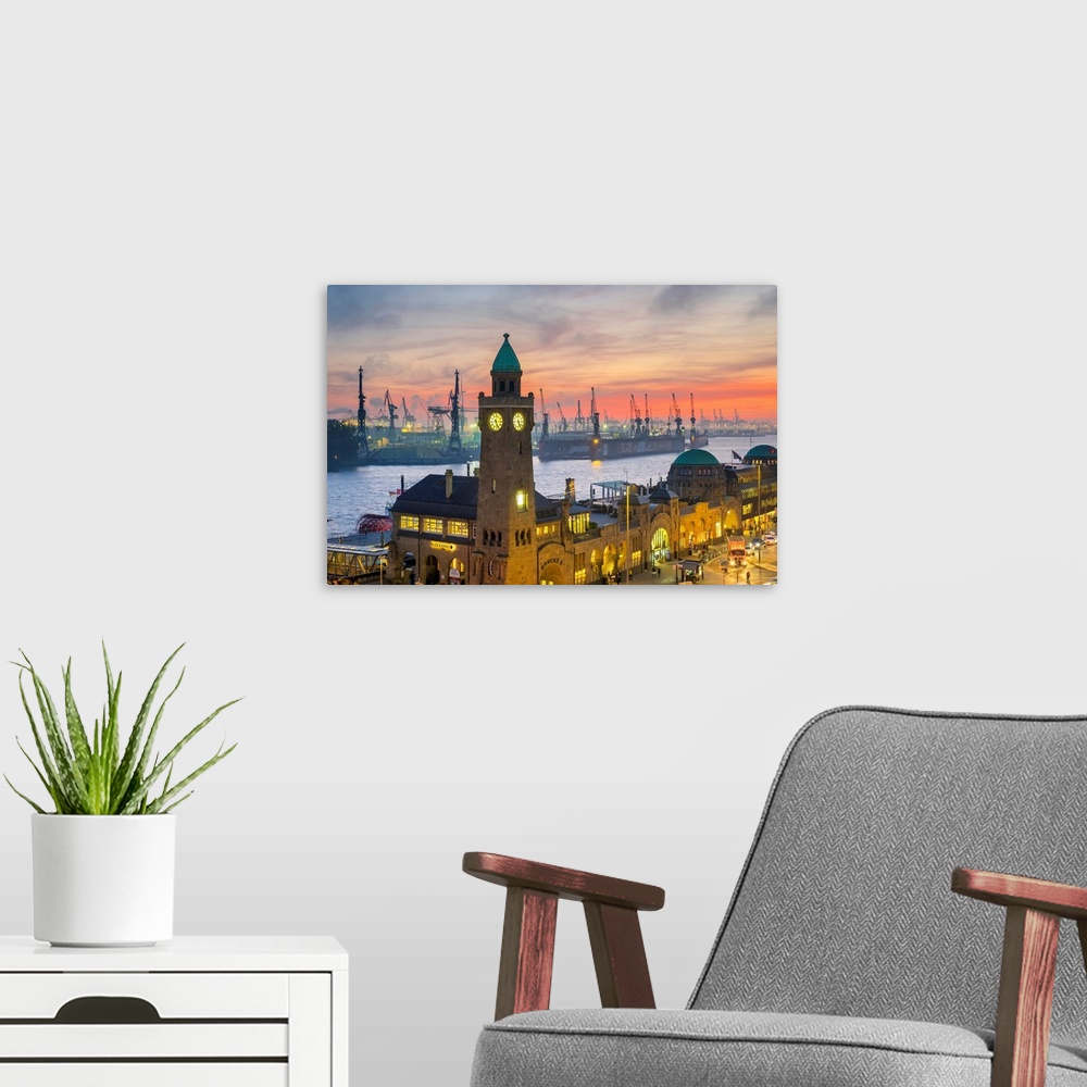 A modern room featuring St. Pauli Landungsbruken and the Elbe River at sunset, Hamburg, Germany.
