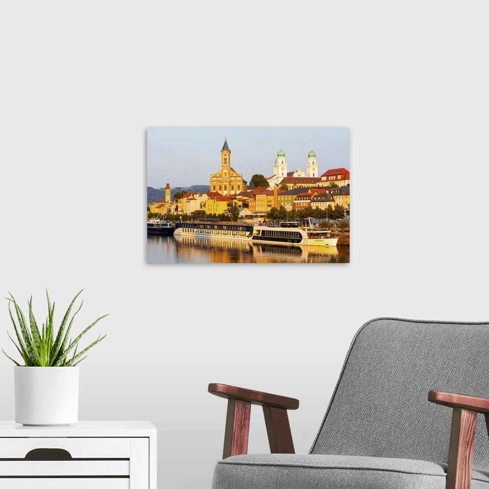 A modern room featuring St. Paul's church and St. Stephan's Cathedral illuminated at sunset, Passau, Lower Bavaria, Bavar...