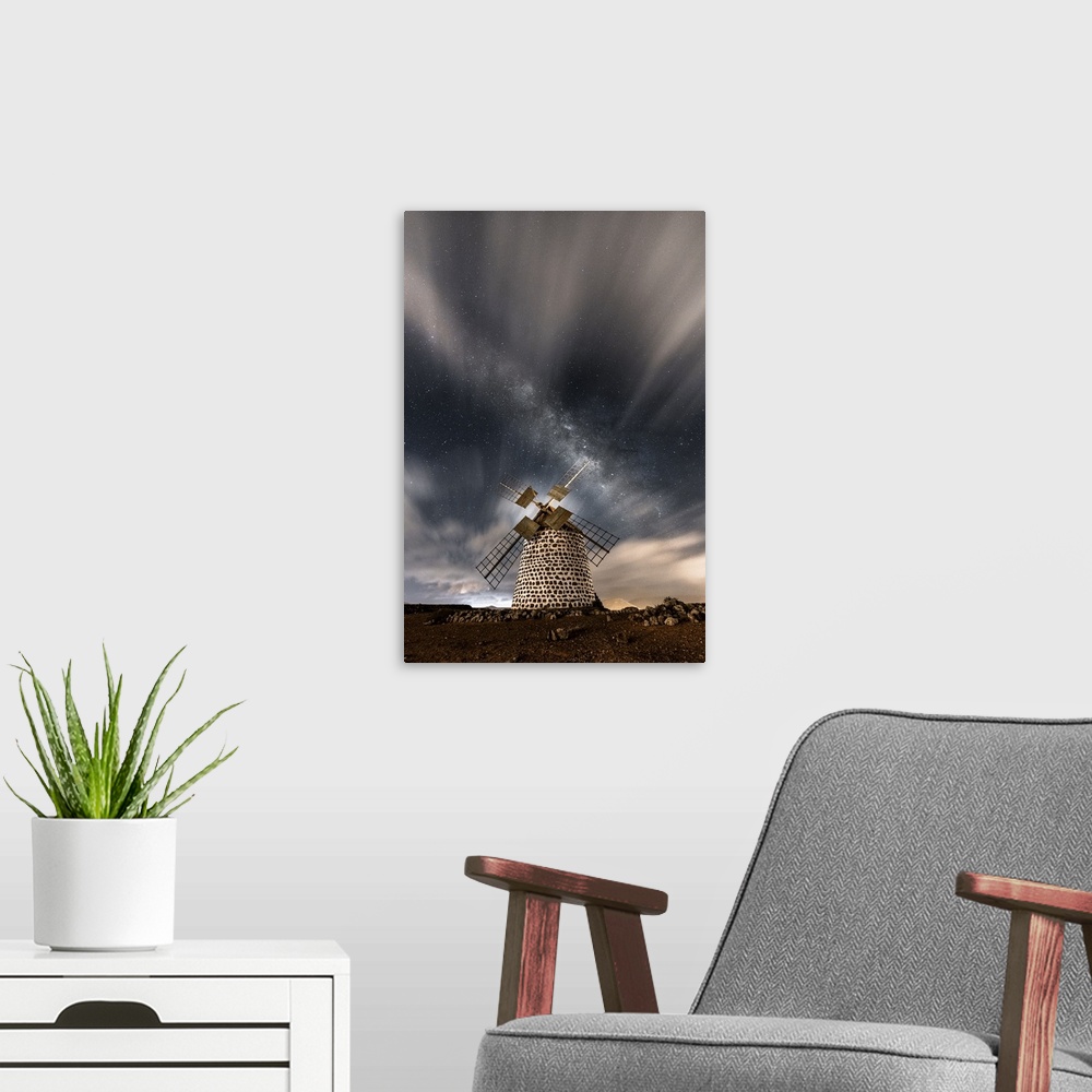 A modern room featuring Starry sky above the stone windmill, La Oliva, Fuerteventura, Canary Islands, Spain.
