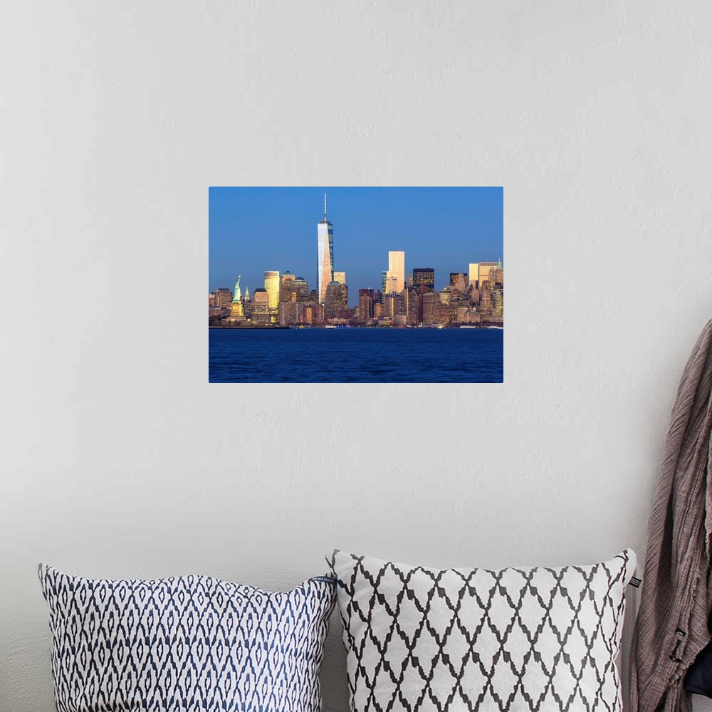 A bohemian room featuring Statue of Liberty, One World Trade Center and Downtown Manhattan across the Hudson River, New Yor...