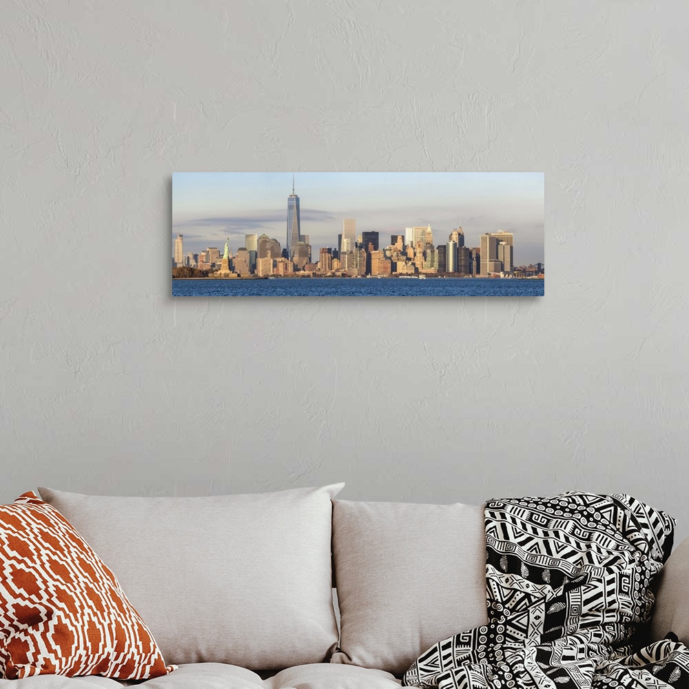 A bohemian room featuring Statue of Liberty, One World Trade Center and Downtown Manhattan across the Hudson River, New Yor...