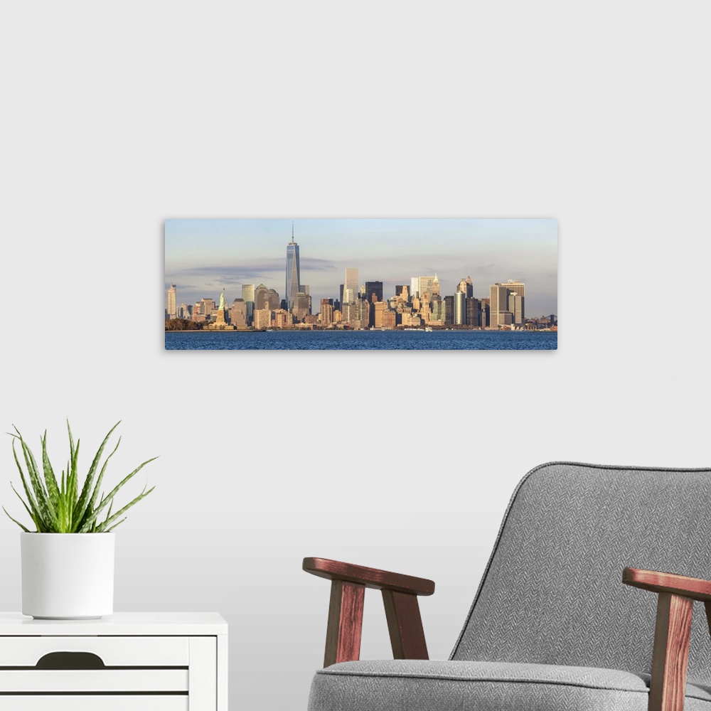 A modern room featuring Statue of Liberty, One World Trade Center and Downtown Manhattan across the Hudson River, New Yor...