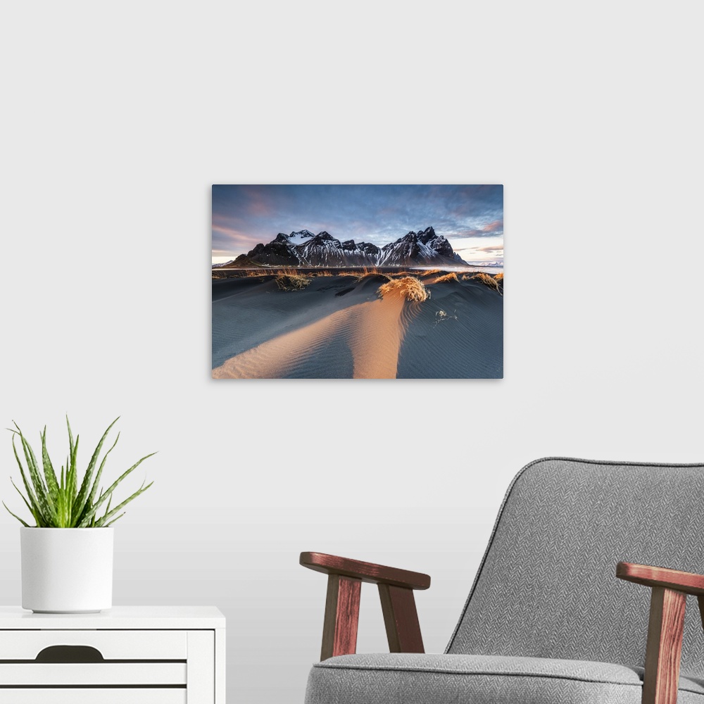 A modern room featuring Stokksnes, Hofn, East Iceland, Iceland. Vestrahorn mountain and the black sand dunes at sunset.