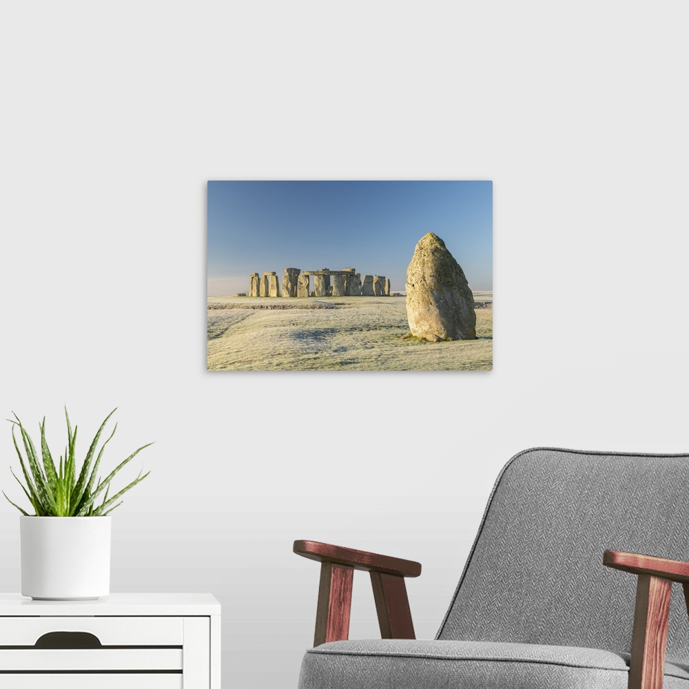 A modern room featuring Stonehenge and the Heel Stone at dawn on a chill frosty winter morning, Wiltshire, England. Winte...
