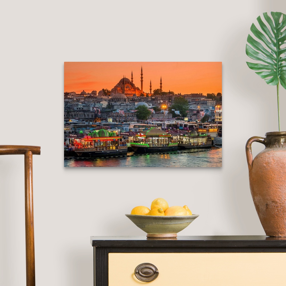 A traditional room featuring Suleymaniye Mosque and city skyline at sunset, Istanbul, Turkey.