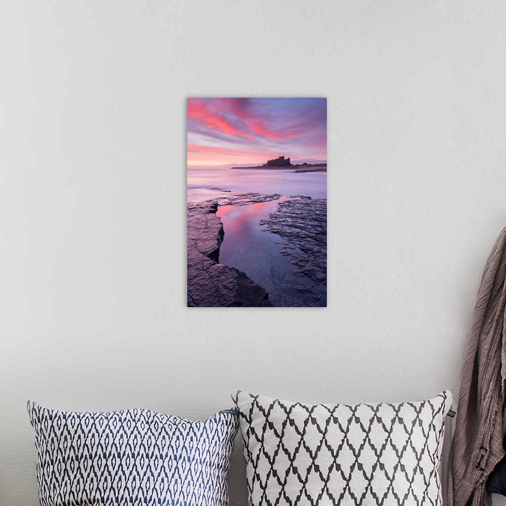 A bohemian room featuring Sunrise over Bamburgh Castle on the Northumberland coast, England. Spring (March) 2015.