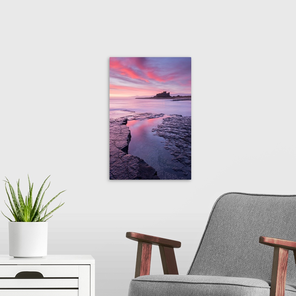 A modern room featuring Sunrise over Bamburgh Castle on the Northumberland coast, England. Spring (March) 2015.