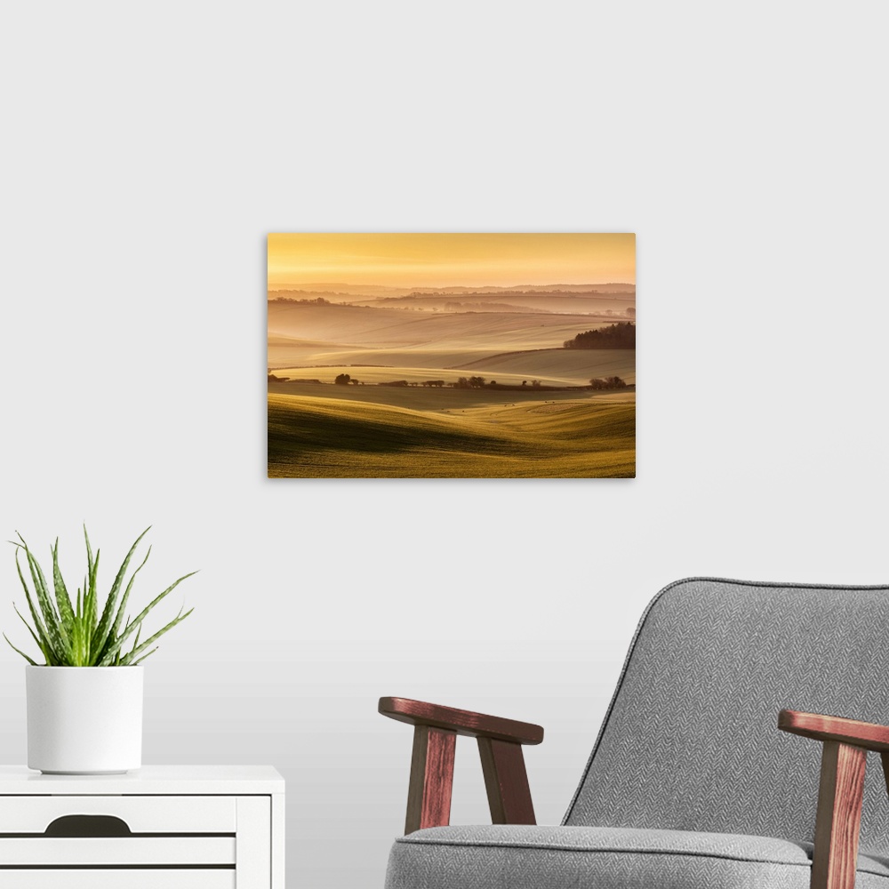 A modern room featuring Sunrise over farmland in the Piddle Valley towards Piddlehinton, Dorset, England, UK.