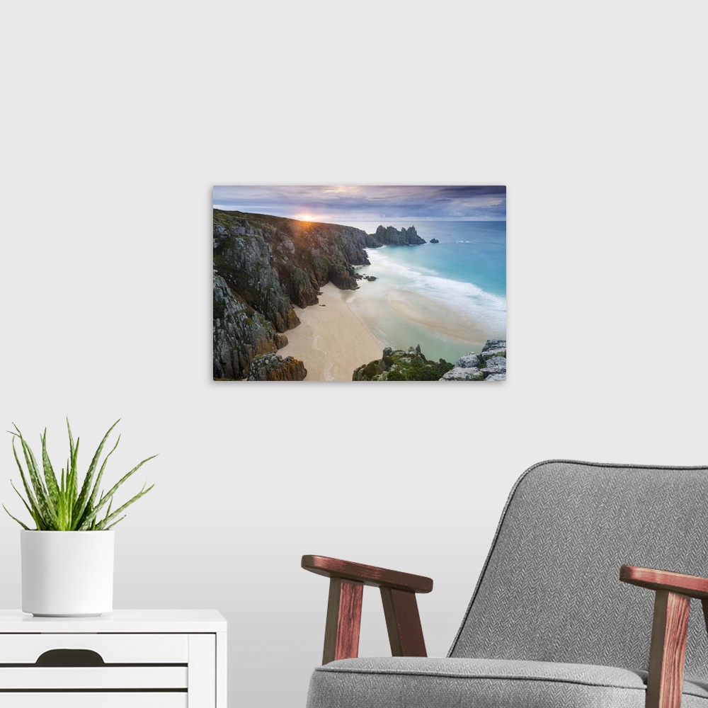 A modern room featuring Sunrise over Pednvounder Beach at the Logan Rock, Cornwall, England.
