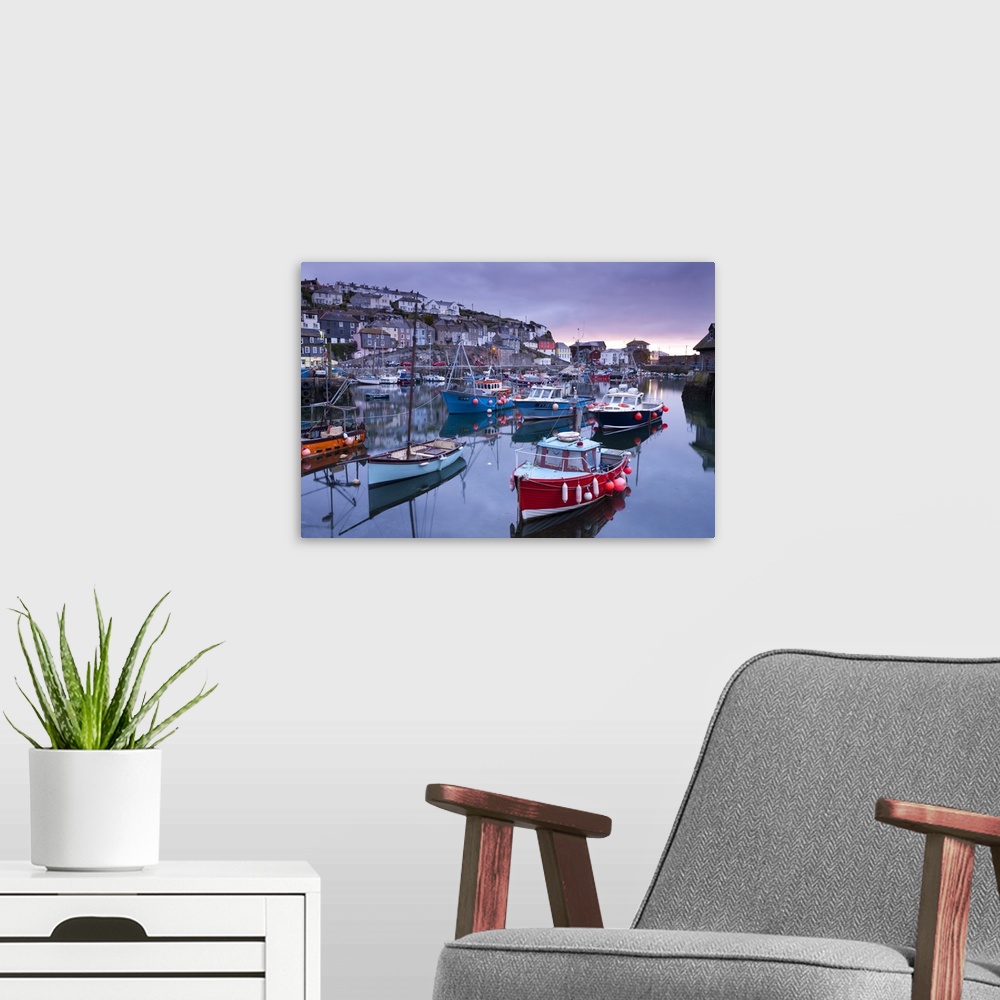 A modern room featuring Sunrise over the picturesque harbour at Mevagissey, Cornwall, England. Spring