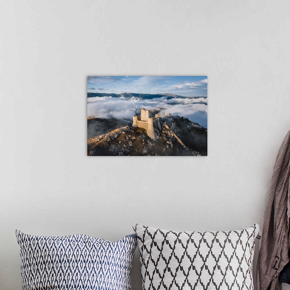 A bohemian room featuring Sunset in Rocca Calascio, an ancient building on the top of a mountain, Gran Sasso National Park,...