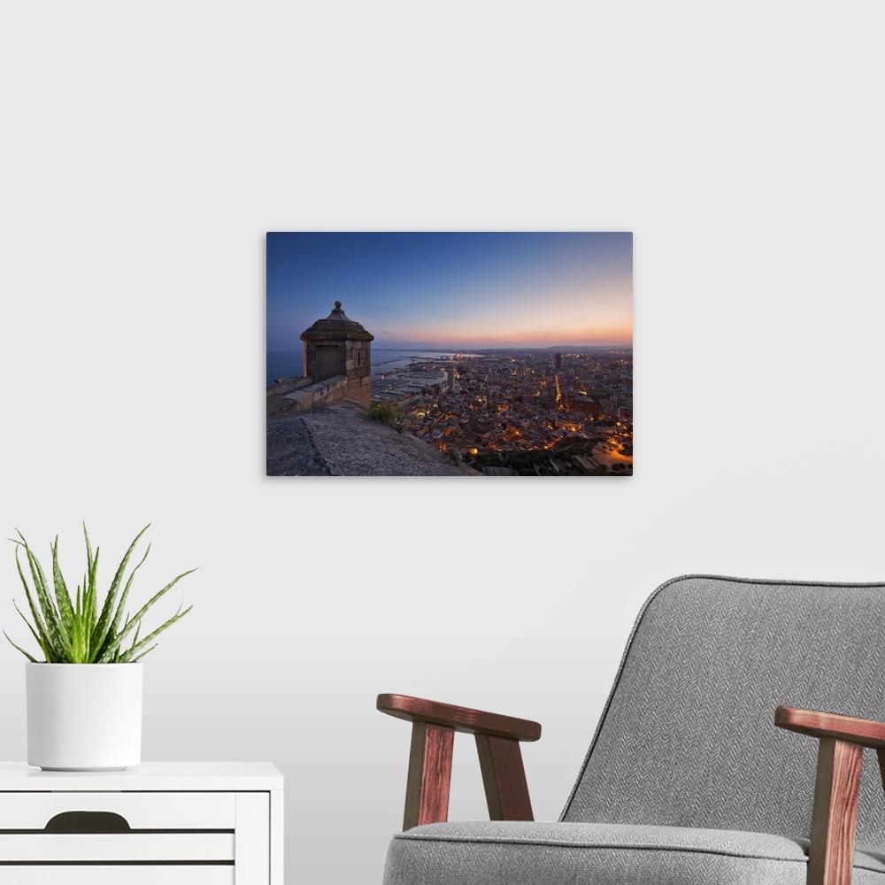 A modern room featuring Sunset view over the cityscape of Alicante looking towards the lookout tower and Port of Alicante...