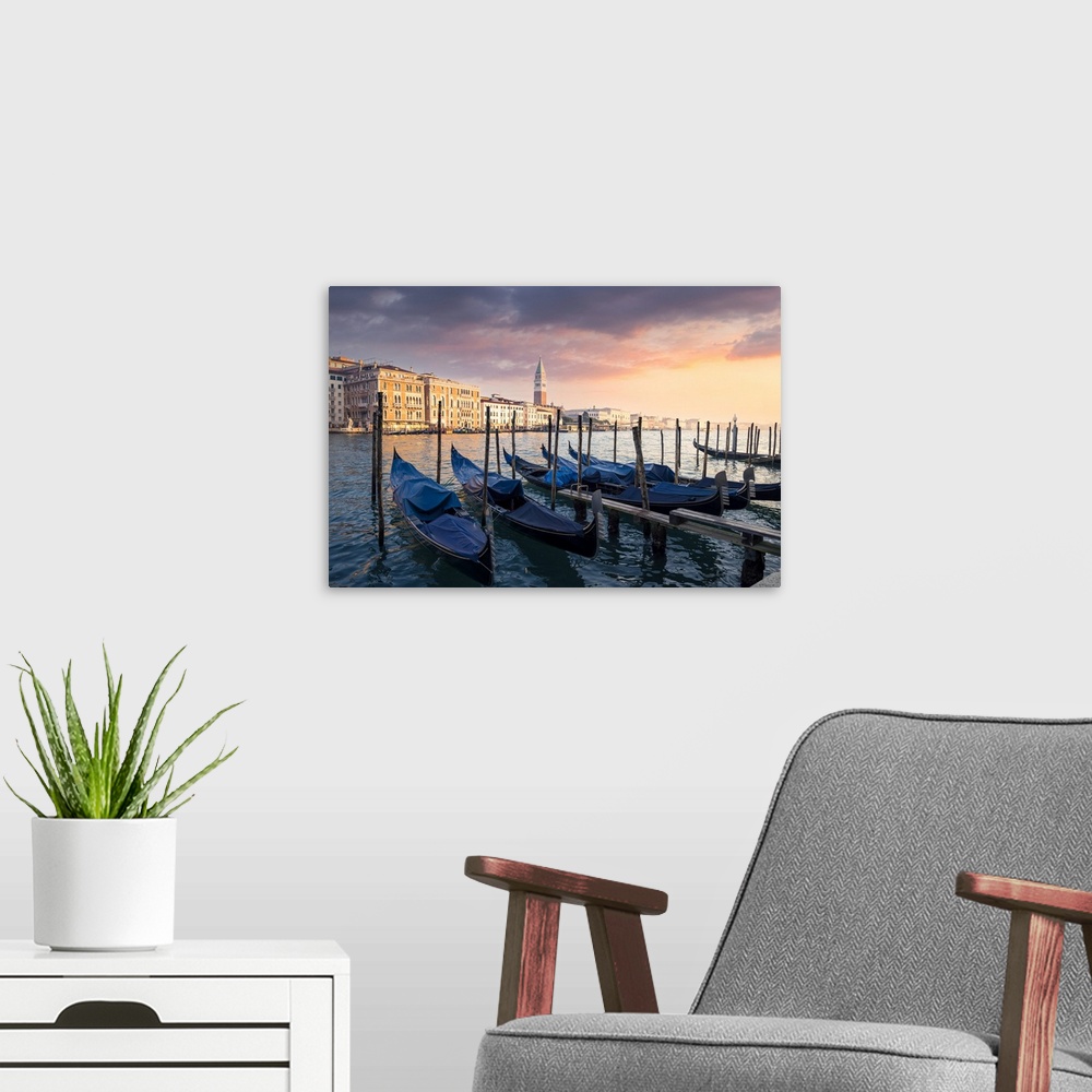 A modern room featuring Sunset with gondolas and St. Mark belltower. Venice, Veneto, Italy.