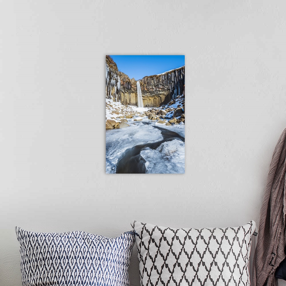 A bohemian room featuring Svartifoss waterfall in winter, Skaftafell national park, East Iceland, Iceland.