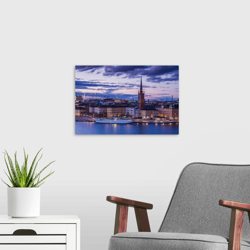 A modern room featuring Sweden, Stockholm, Gamla Stan, Old Town, elevated city view with Riddarholmeskyrkan church, dusk