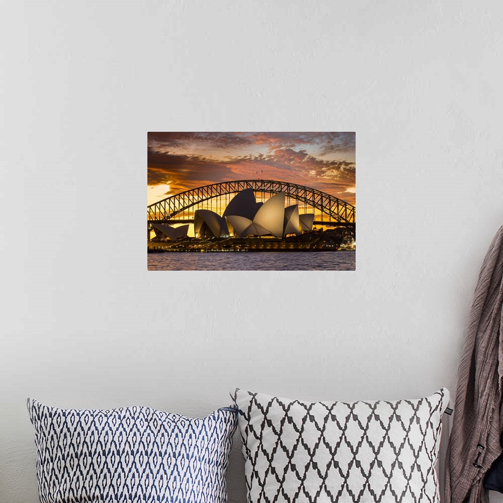 A bohemian room featuring Sydney Opera House and Sydney Harbour Bridge at dusk, Sydney, New South Wales, Australia.