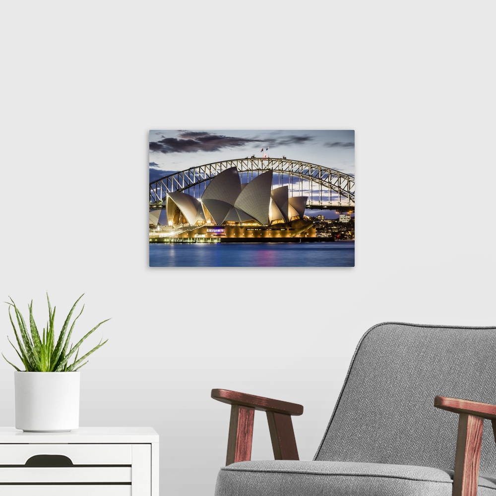 A modern room featuring Sydney Opera House and Sydney Harbour Bridge at dusk, Sydney, New South Wales, Australia.