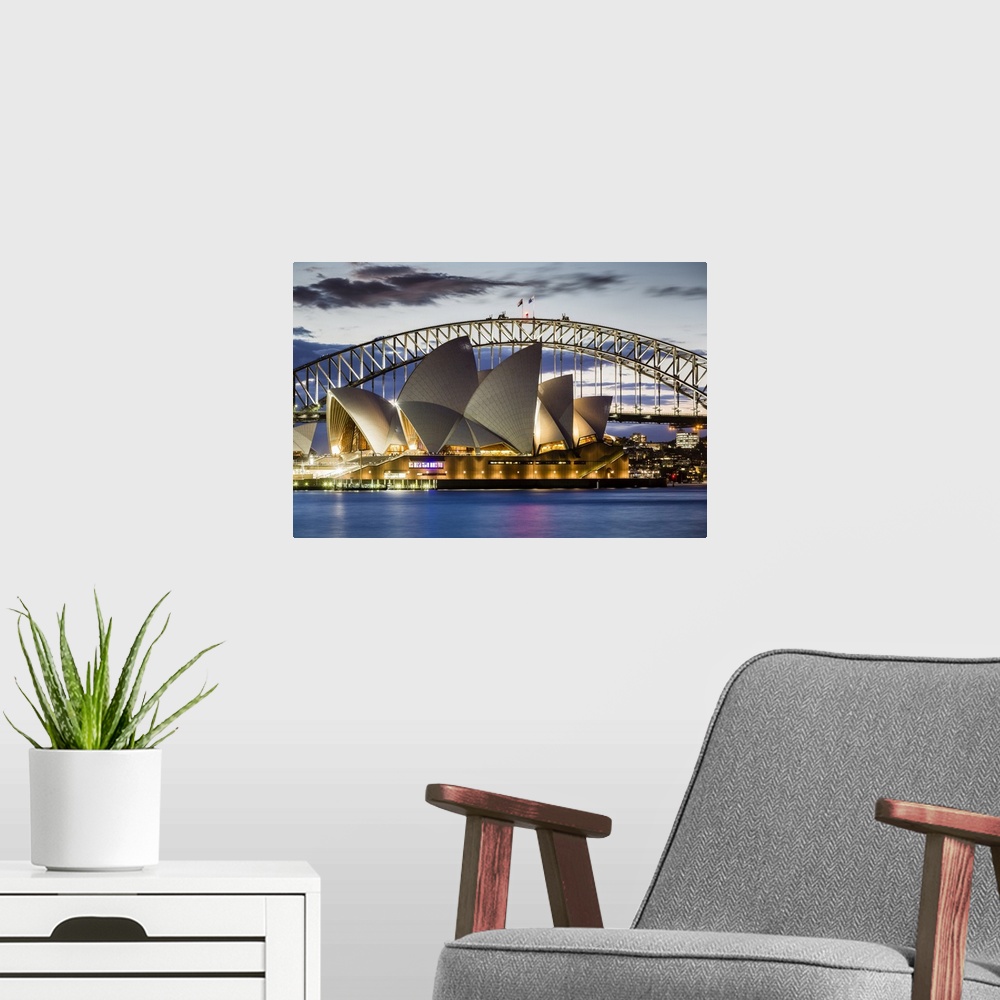 A modern room featuring Sydney Opera House and Sydney Harbour Bridge at dusk, Sydney, New South Wales, Australia.