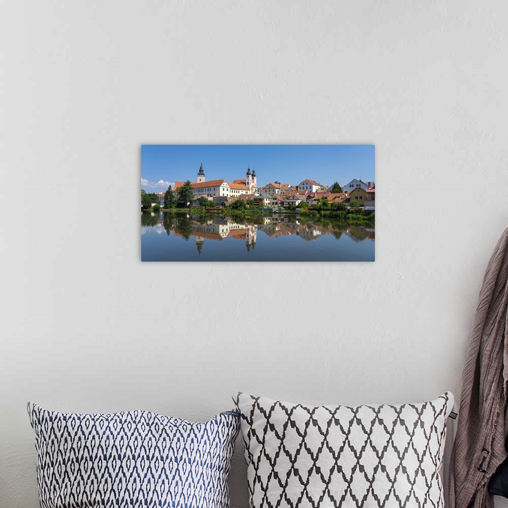 A bohemian room featuring Telc Chateau reflected in Ulicky pond, UNESCO, Telc, Jihlava District, Vysocina Region, Czech Rep...