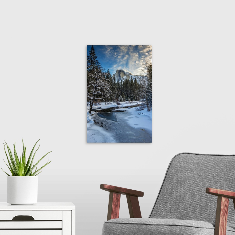 A modern room featuring Winter view over icy Tenaya creek with Half Dome mountain behind, Yosemite National Park, Califor...