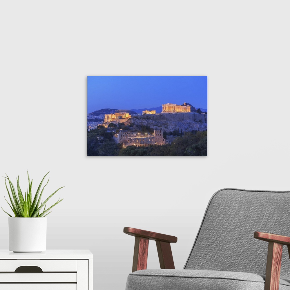 A modern room featuring The Acropolis illuminated by floodlight, Athens, Greece