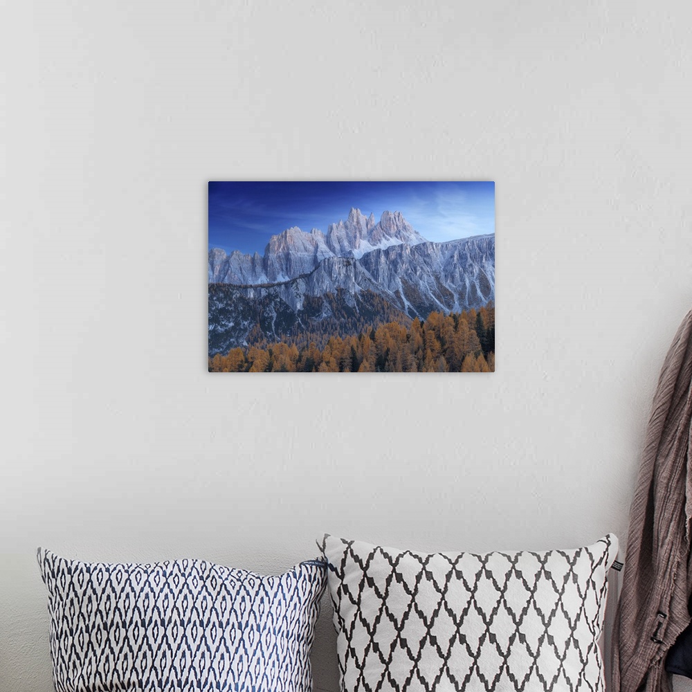 A bohemian room featuring The Croda da Lago and Lastoi de Formin mountains at twilight, with the golden larches glowing in ...