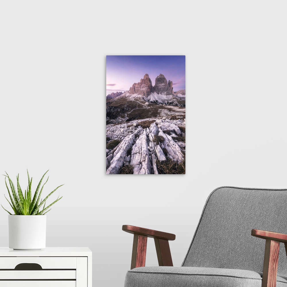 A modern room featuring The iconic Tre Cime di Lavaredo during a clear autumn sunset. Dolomites, Italy.