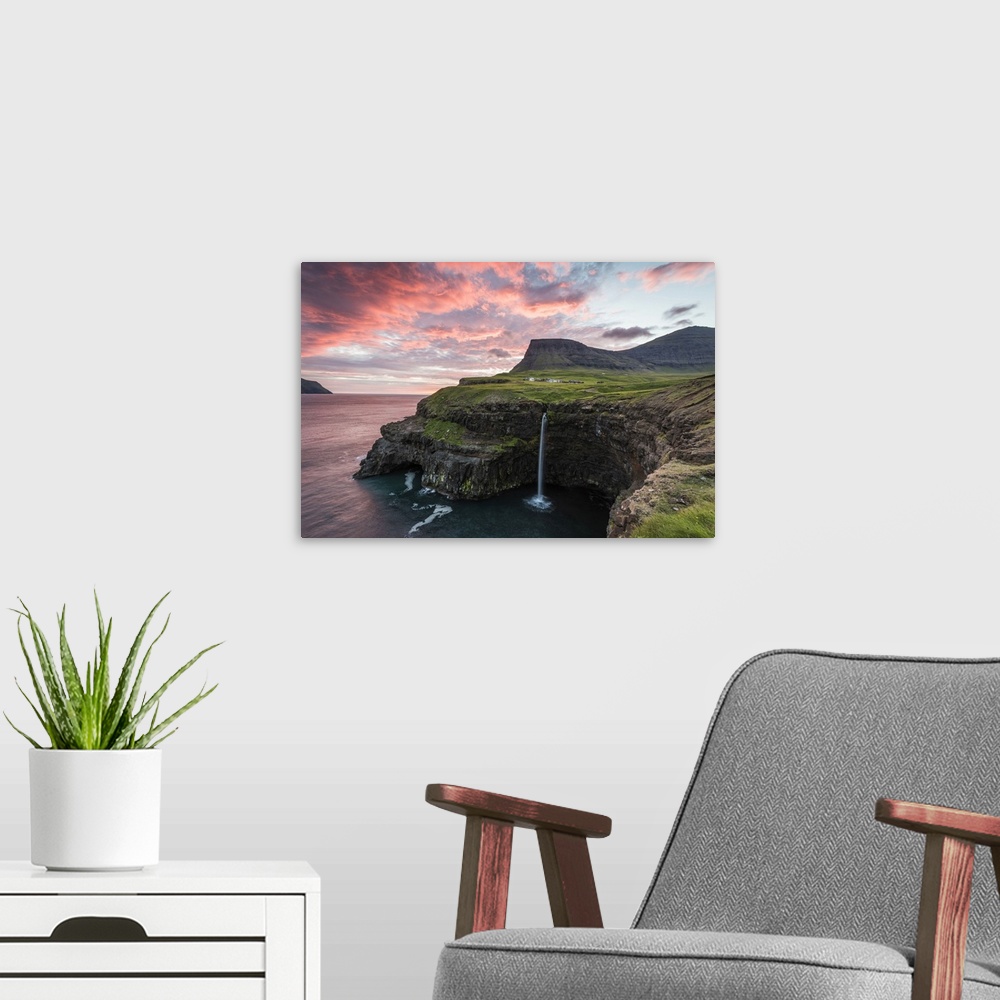 A modern room featuring Gasadalur, Vagar island, Faroe Islands, Denmark. The iconic waterfall jumping from the cliff into...