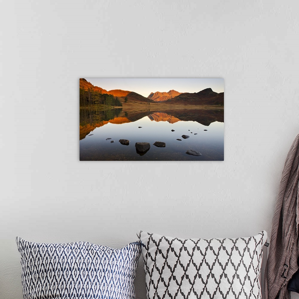 A bohemian room featuring The Langdale Pikes reflected in a mirrorlike Blea Tarn at sunrise, Lake District National Park, C...