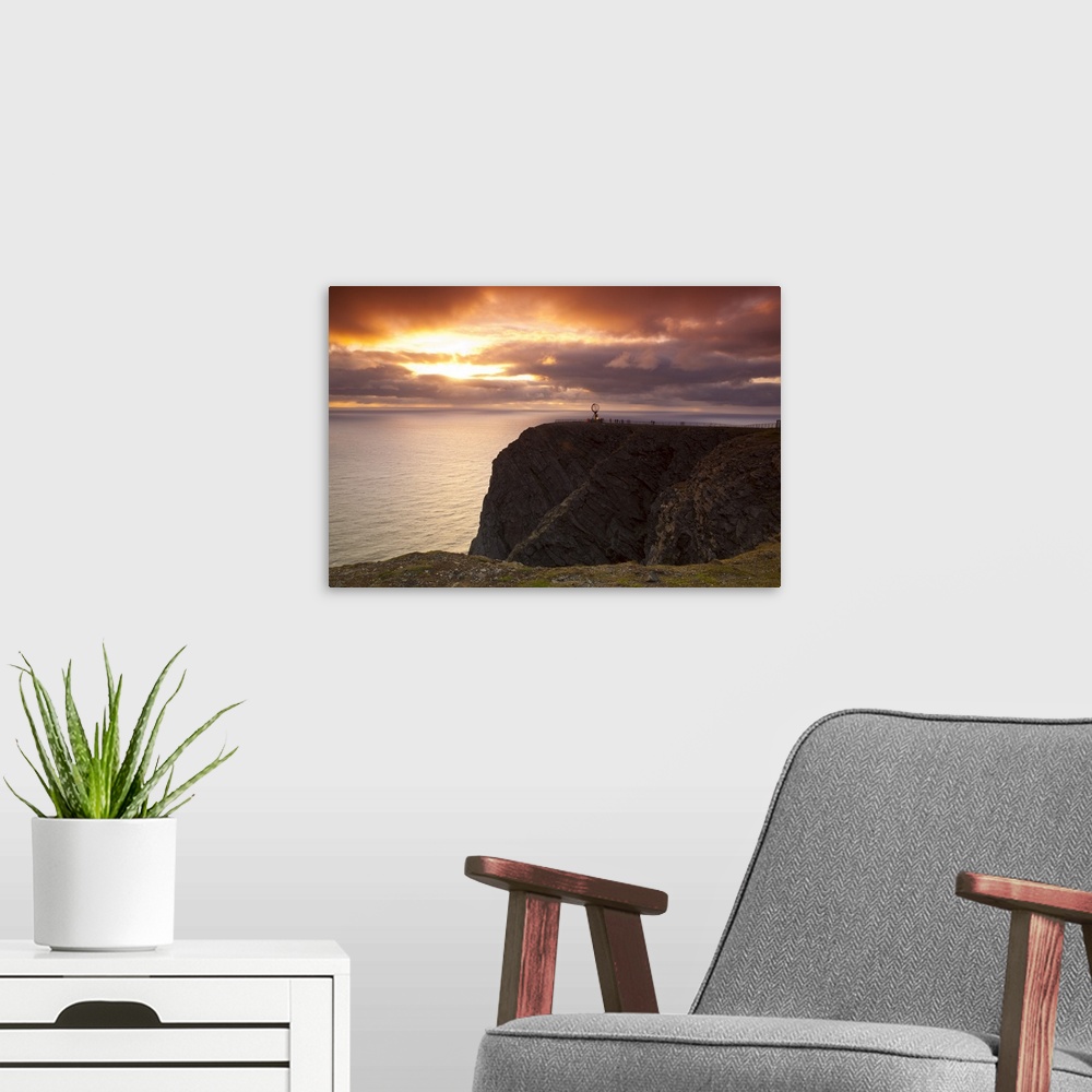 A modern room featuring The Midnight Sun breaks through the clouds at Nordkapp, Finnmark, Norway