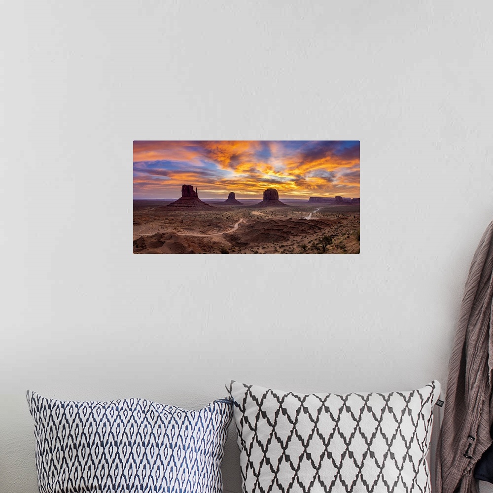 A bohemian room featuring The Mittens against colourful cloudy sky at sunrise, Monument Valley, Arizona, USA