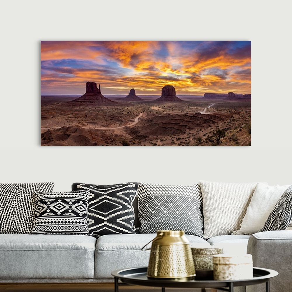 A bohemian room featuring The Mittens against colourful cloudy sky at sunrise, Monument Valley, Arizona, USA