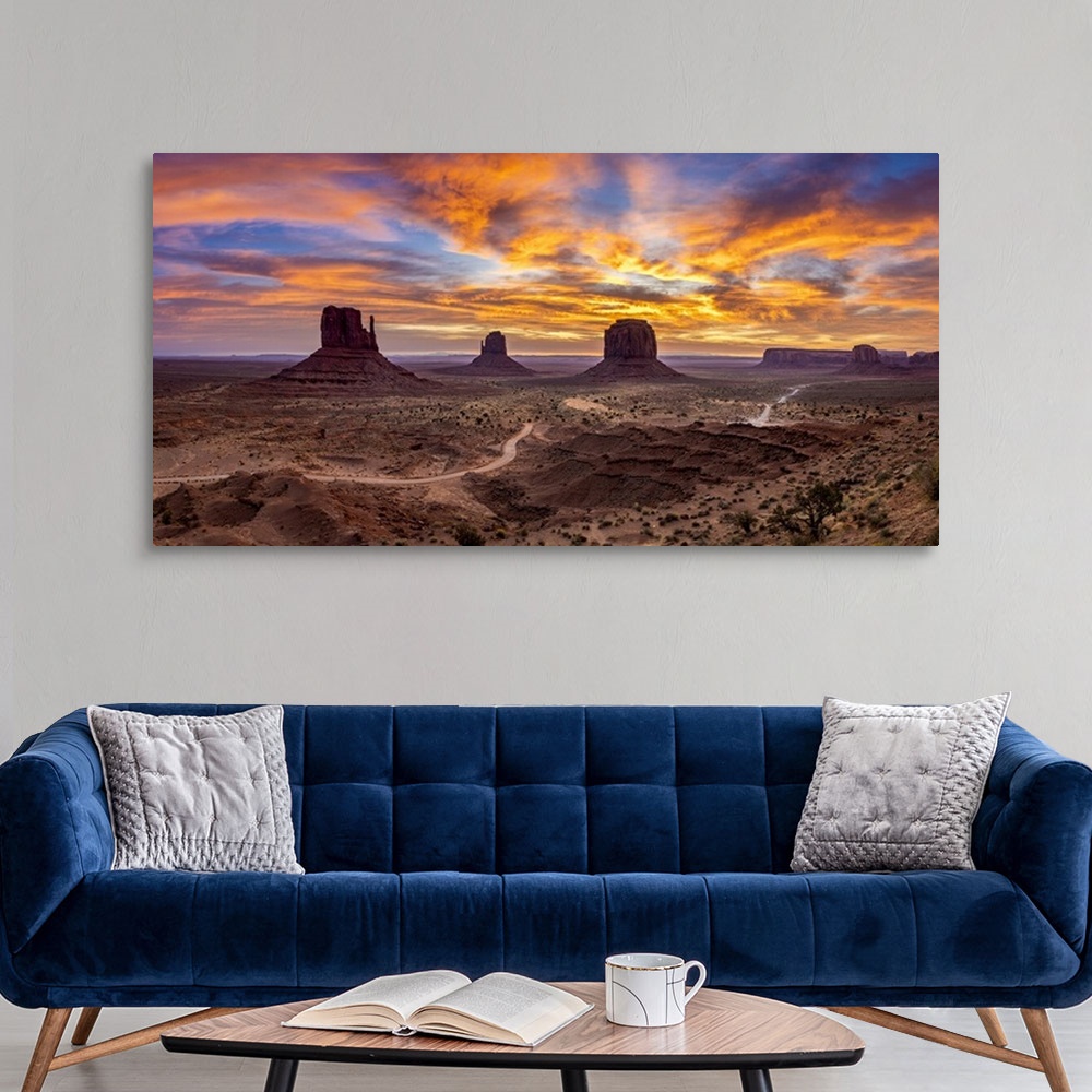 A modern room featuring The Mittens against colourful cloudy sky at sunrise, Monument Valley, Arizona, USA