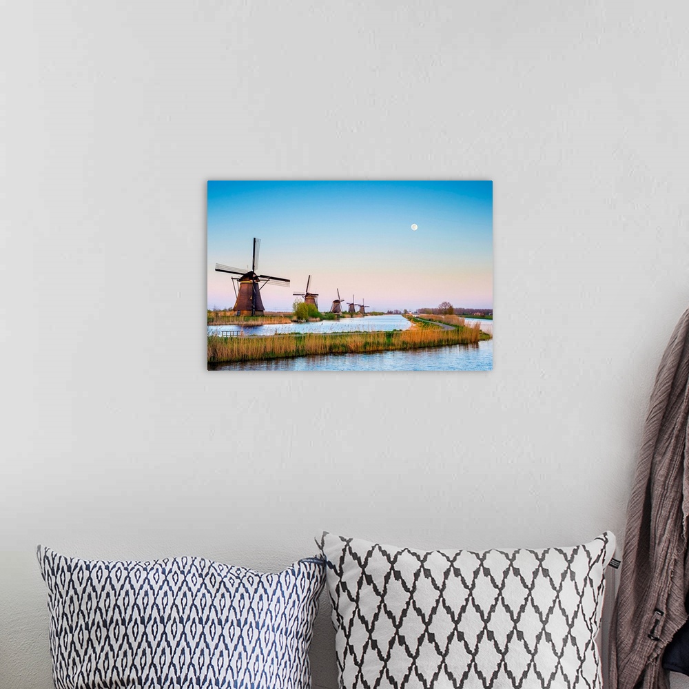 A bohemian room featuring Netherlands, South Holland, Kinderdijk, UNESCO World Heritage Site. The moon rises above historic...